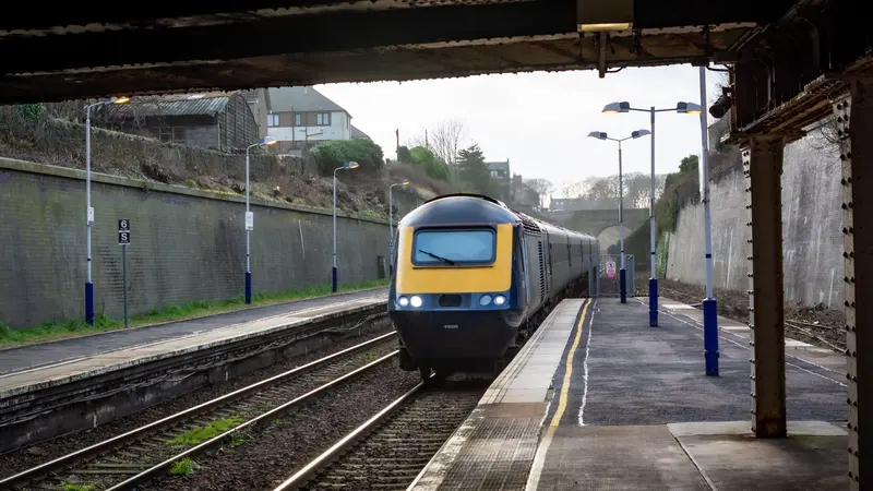 A train for Aberdeen arriving at Arbroath, seen from under the station canopy, with both platforms and the cutting wall