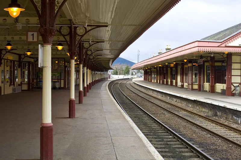 Under the long platform 1 canopy at Aviemore, with cream cast-iron columns, hanging lamps and the island platform opposite