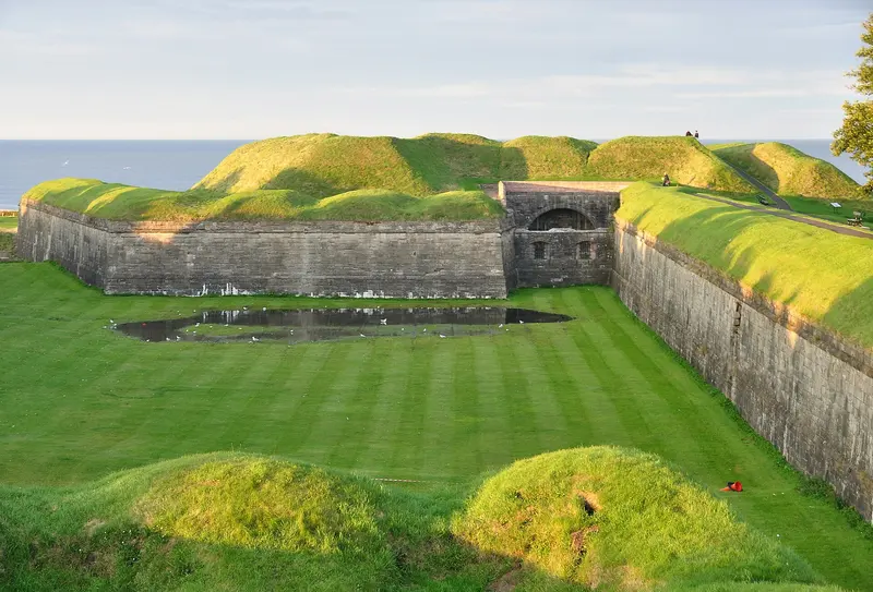 A grassy bastion of Berwick's Elizabethan ramparts, with stone-faced walls, a flooded ditch and the North Sea beyond