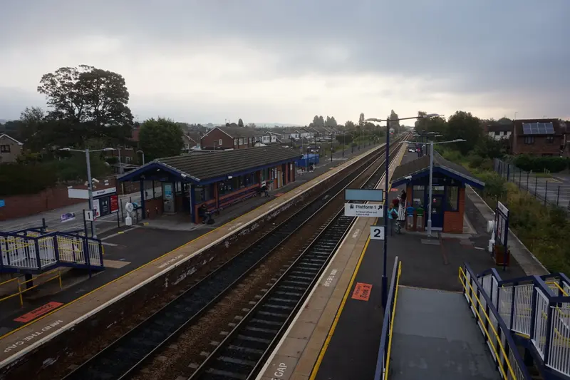 Brough station's two platforms and waiting rooms seen from the footbridge