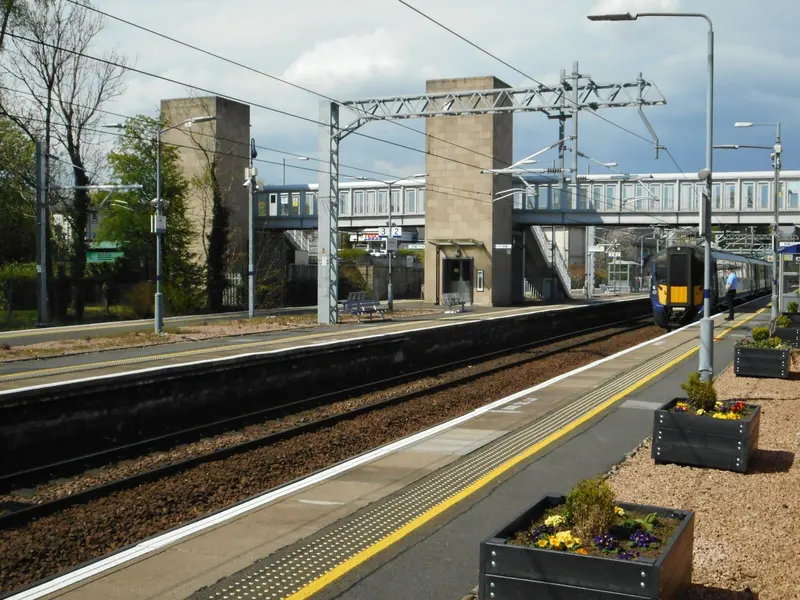 Platforms at Dunblane station with overhead electric wires and the footbridge towers