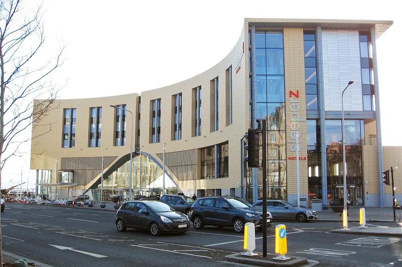 Dundee's curved, five-storey station building of 2018 with a glazed entrance and a hotel on the upper floors