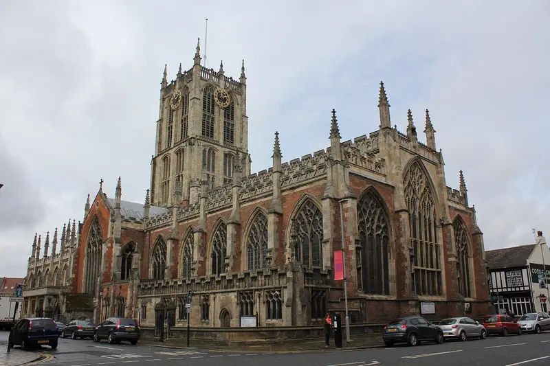 Hull Minster's great Gothic windows and central tower seen from Market Place