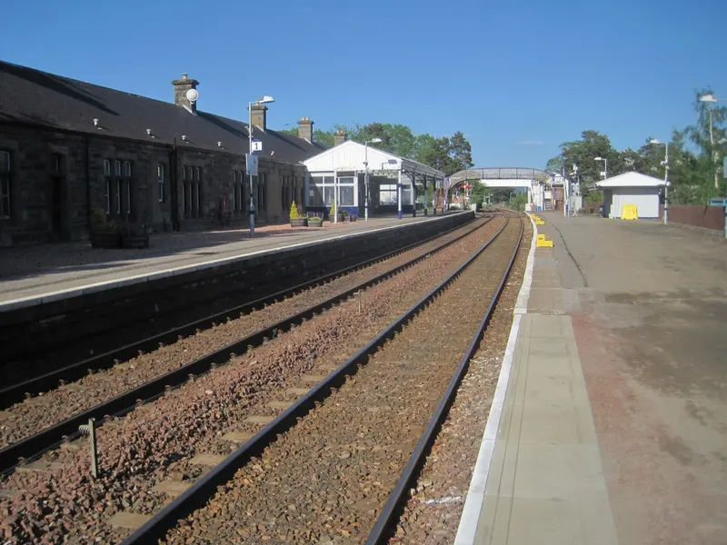 The long single-storey stone station building at Kingussie beside the platform