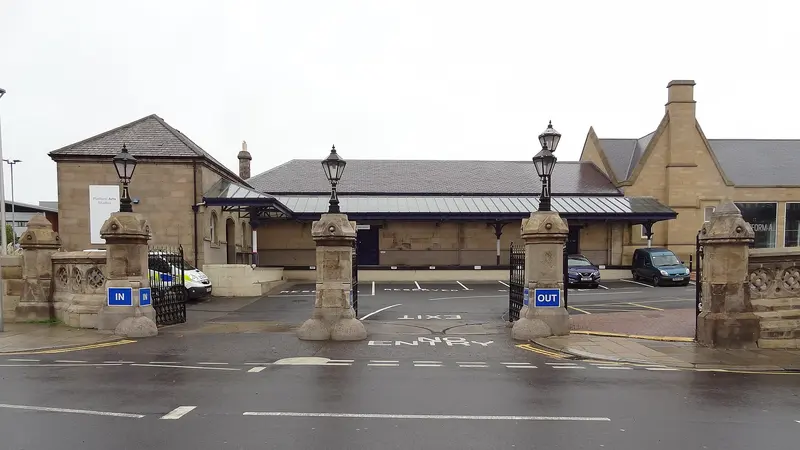 Stone gate piers topped with lamps at the entrance to Middlesbrough station's forecourt
