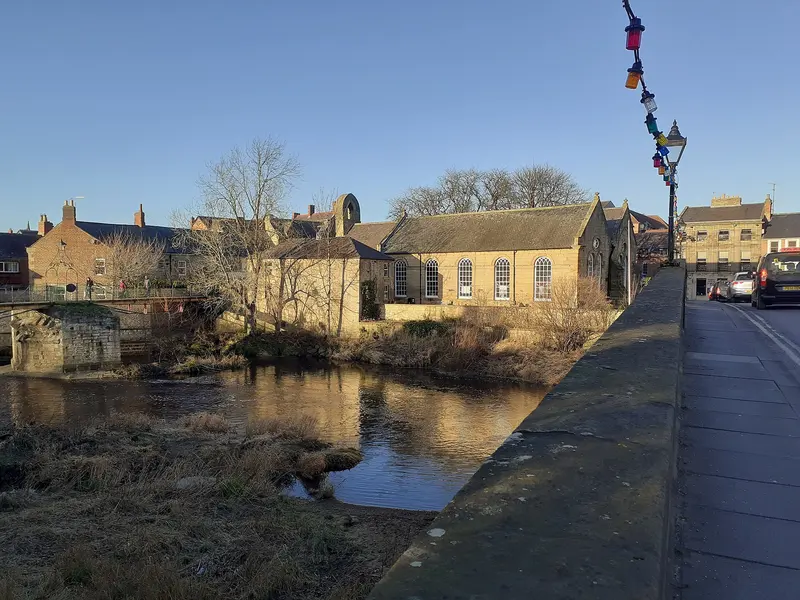 The stone Chantry building beside the River Wansbeck in Morpeth, seen from the Telford Bridge