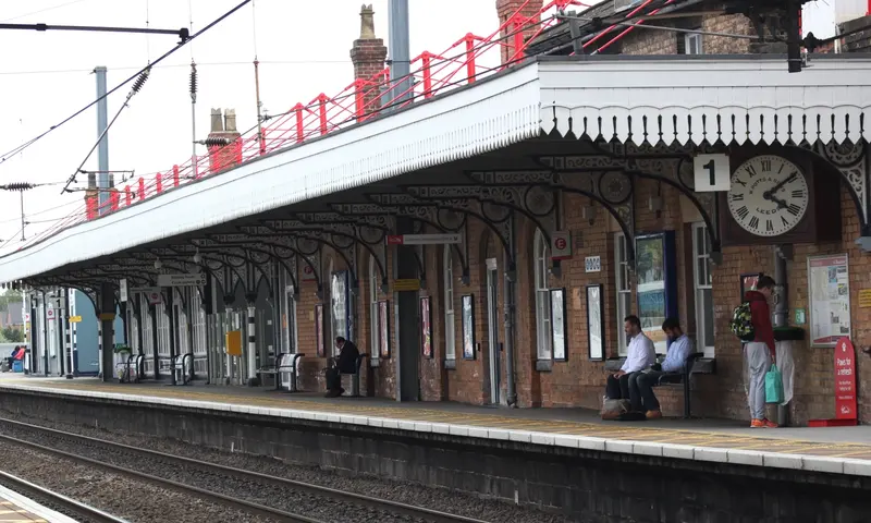 Platform 1 at Newark Northgate, with a long brick building under a canopy with decorative iron brackets and a large clock