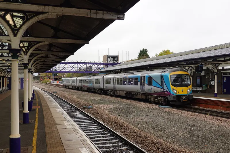 A TransPennine Express train at Selby station beneath Victorian platform canopies