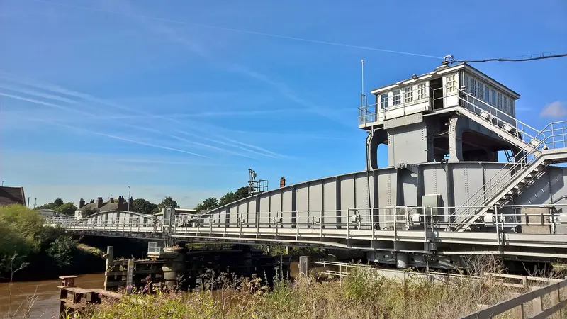 The steel railway swing bridge over the River Ouse at Selby with its raised control cabin