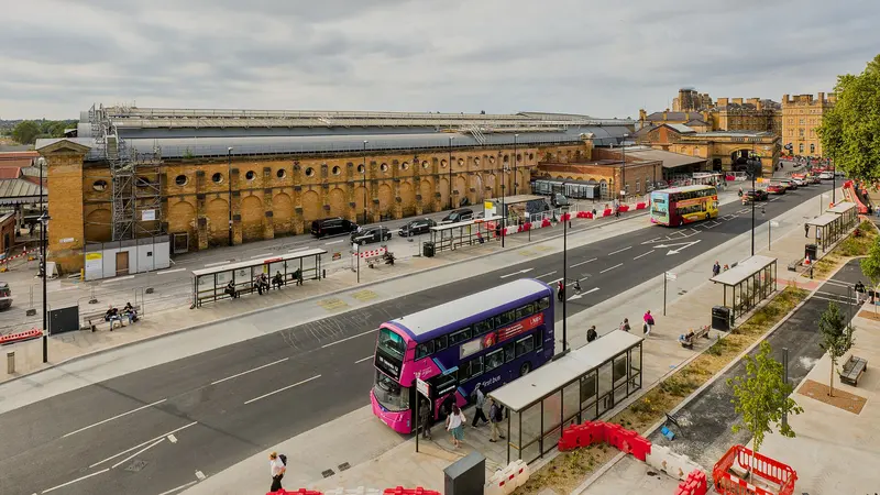 York station's long brick frontage and bus stops seen from the city walls